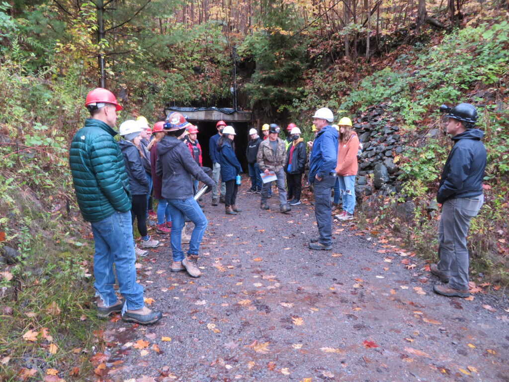 Tour group getting briefed outside the mine entrance for an underground mine tour at quincy mine.